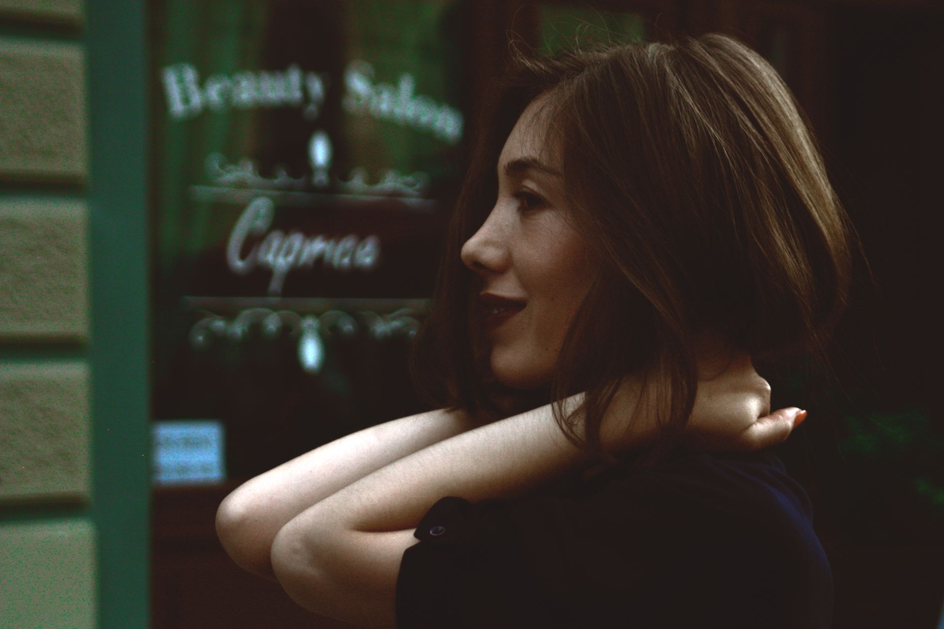 Side view of a smiling woman in front of a beauty salon, showcasing happiness and style. — How Businesses Improve Visibility