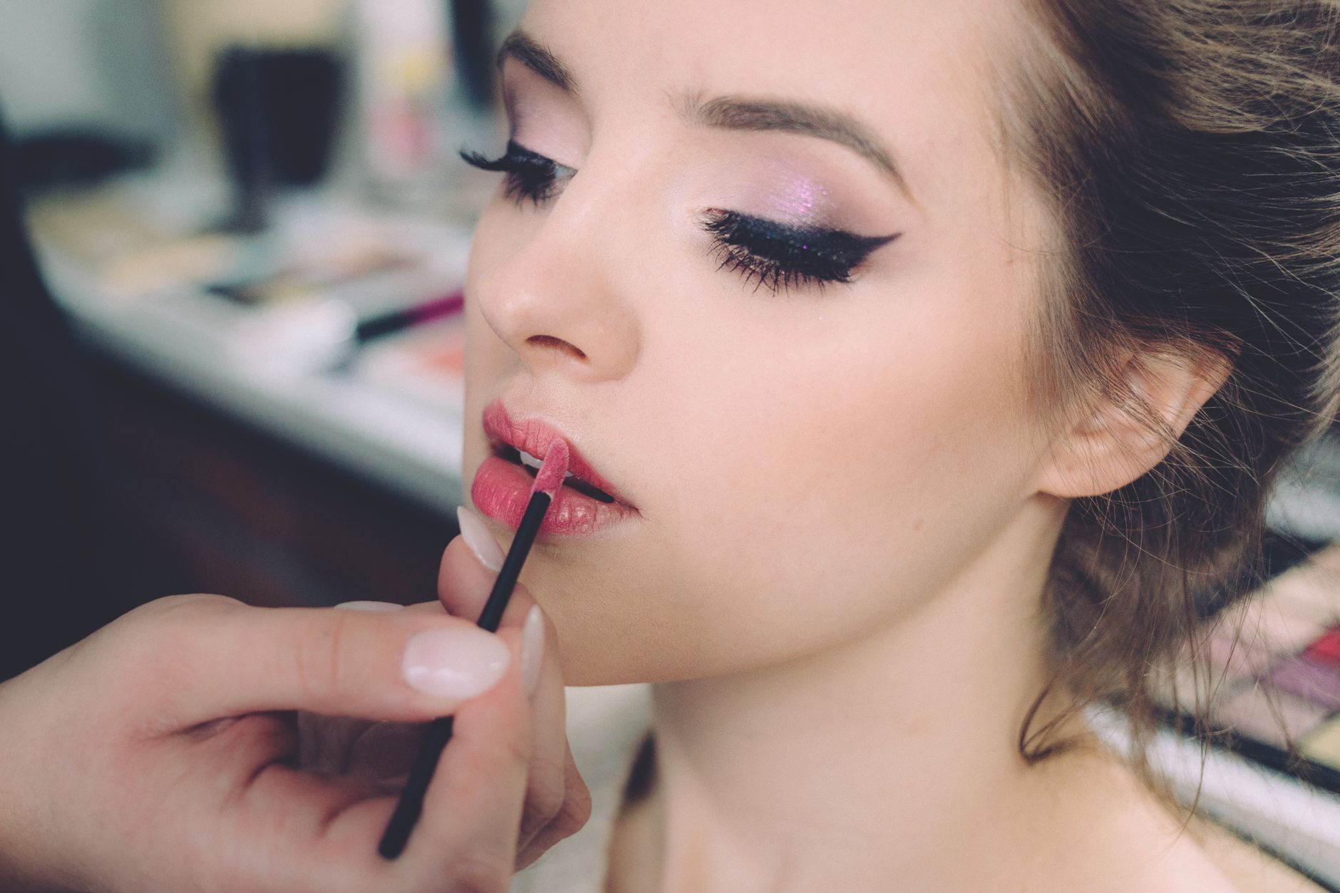Close-up of an elegant woman having makeup applied, highlighting fashion and beauty. — Test post title