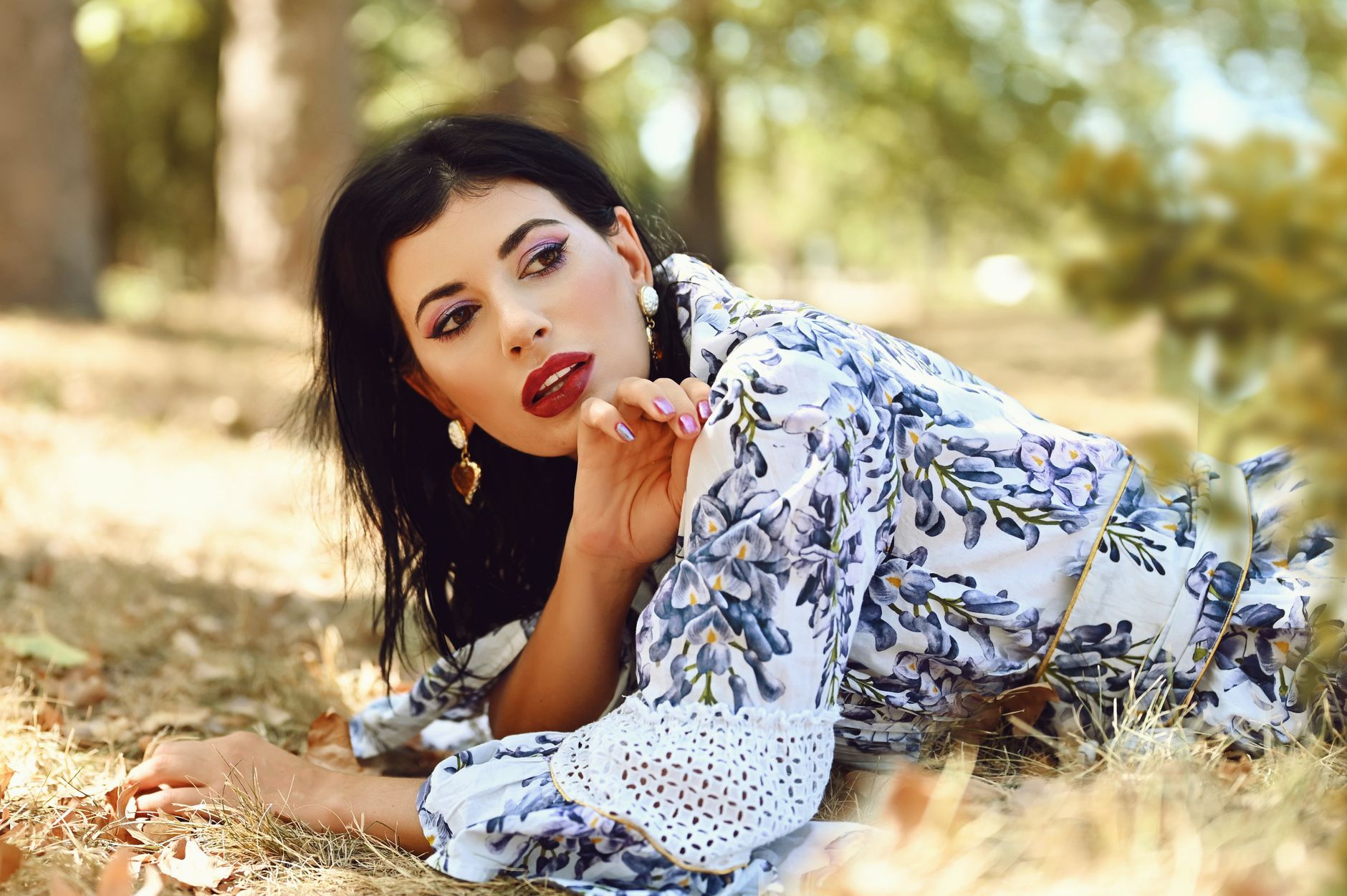 Portrait of a stylish woman lying on grass in summer with elegant attire. — Verify vavada account